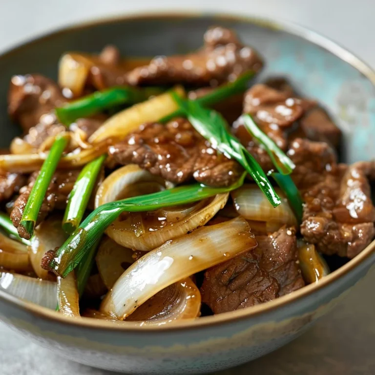 Delicious Chinese beef and onion stir fry served with rice and vegetables