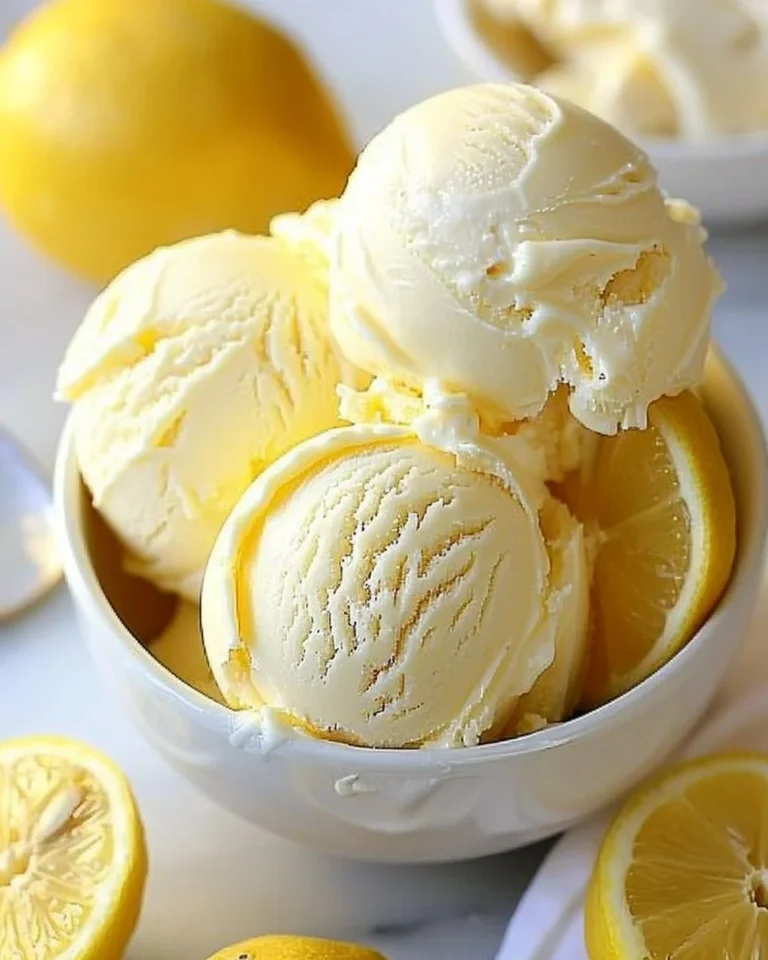 Delicious creamy lemon ice cream in a bowl, topped with fresh lemon zest.
