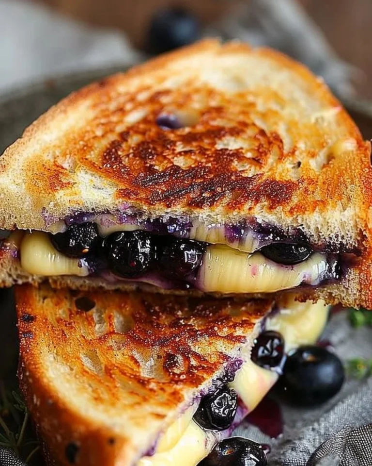 Juicy blueberry grilled cheese sandwich with melted cheese and fresh blueberries