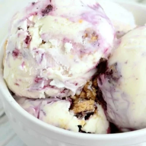 Lemon Blueberry Cheesecake Ice Cream in a bowl topped with fresh blueberries