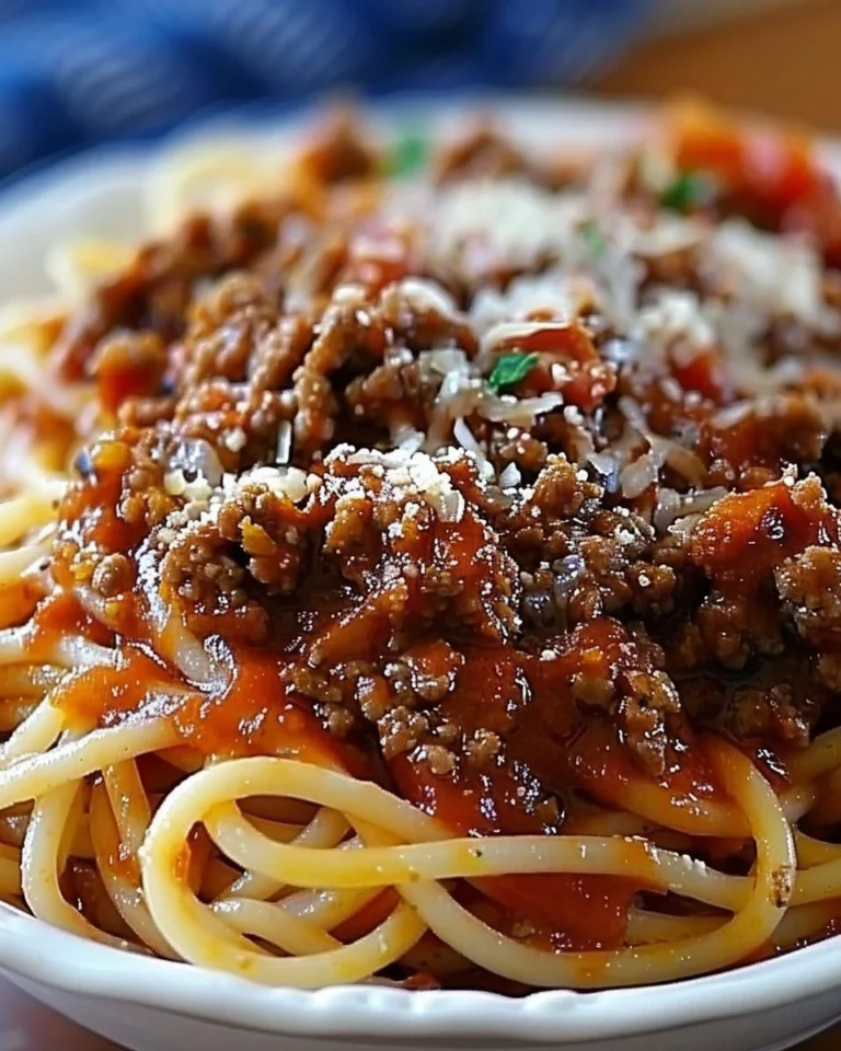 Plate of spaghetti with meat sauce served in a school cafeteria setting
