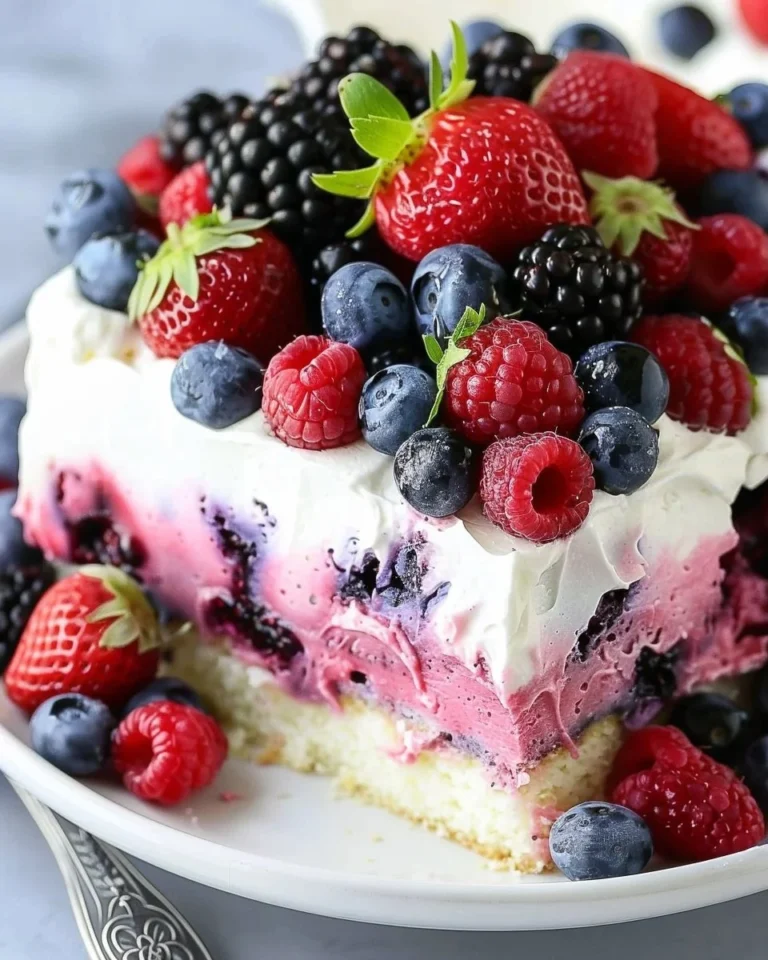 Delicious no-bake summer berry poke cake with fresh berries and creamy topping