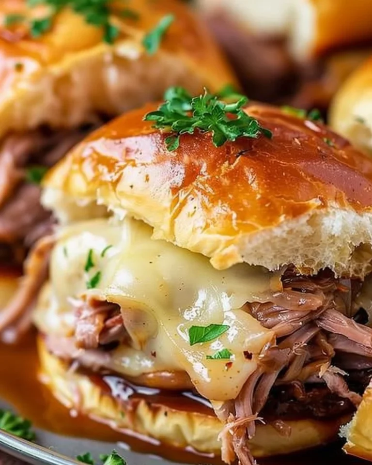 Plate of homemade French Dip Sliders with au jus dip