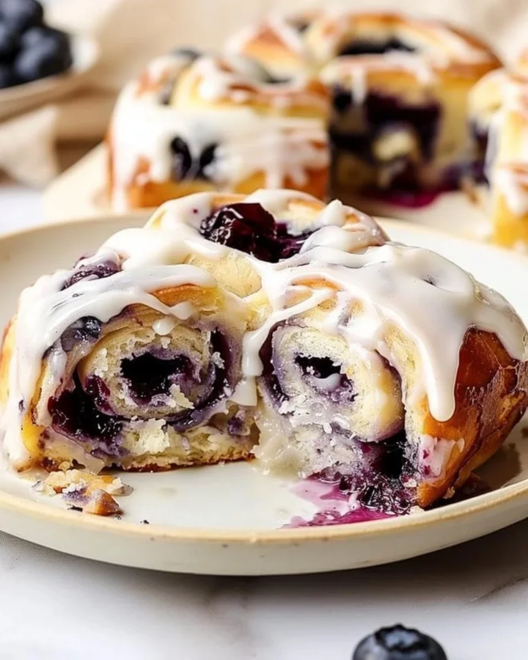 Lemon Blueberry Sweet Rolls fresh out of the oven, drizzled with icing.
