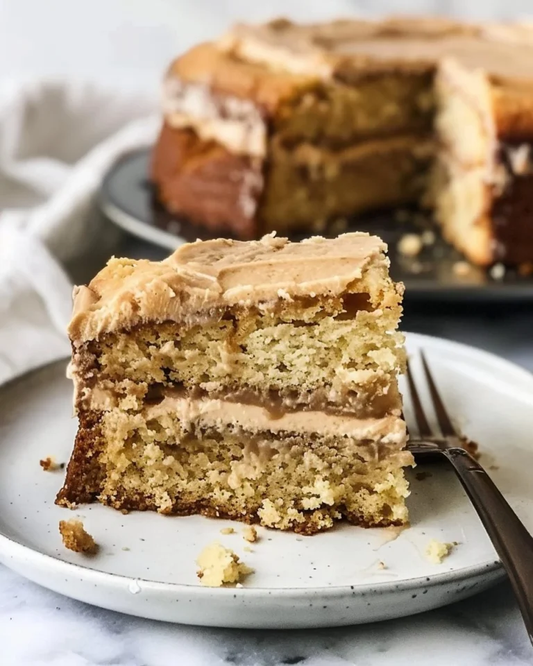 Delicious brown butter coffee cake slice on a plate with crumbs