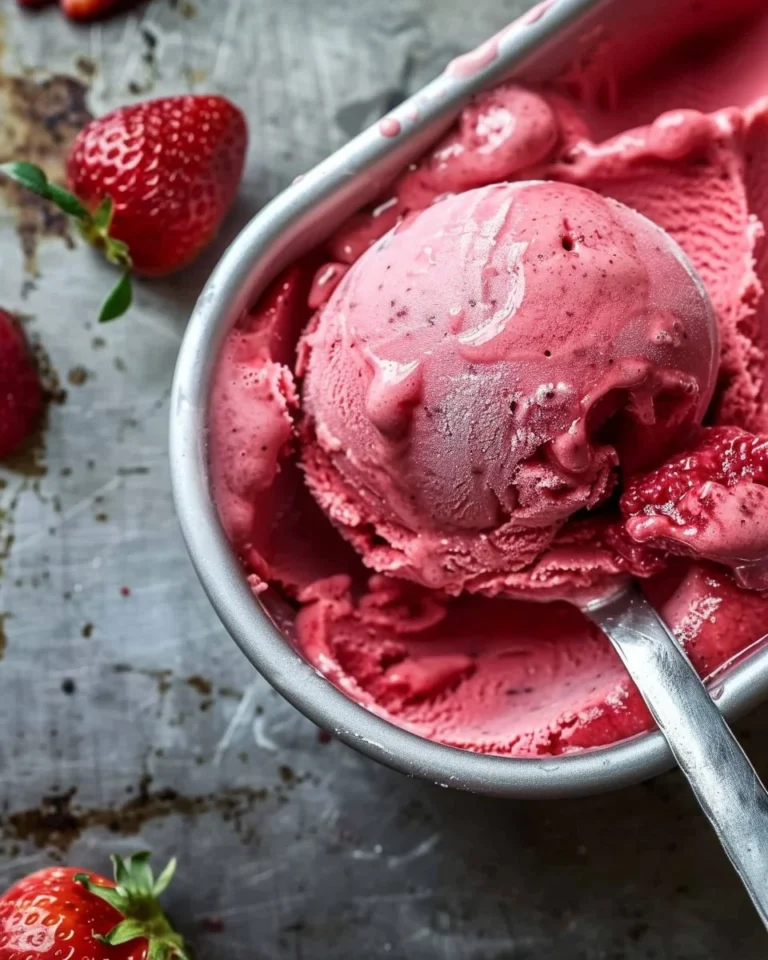 Delicious strawberry gelato in a bowl with fresh strawberries on top