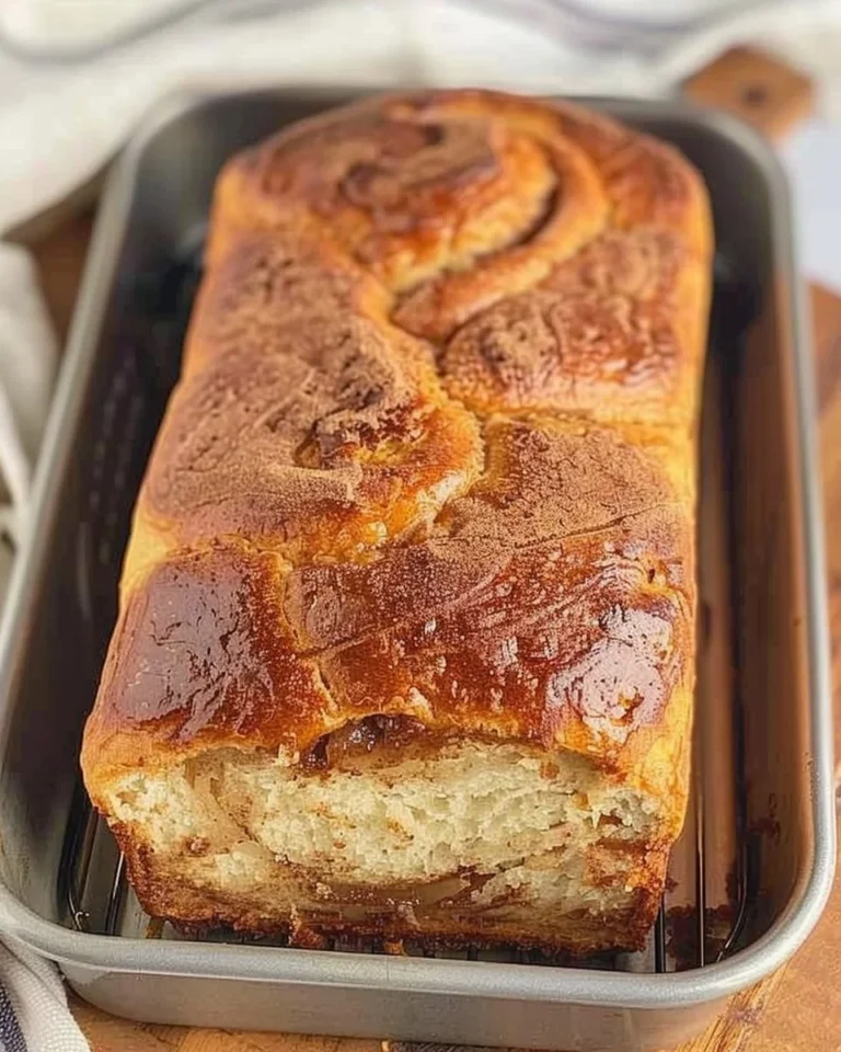 Loaf of freshly baked cinnamon swirl bread with spiral cinnamon filling