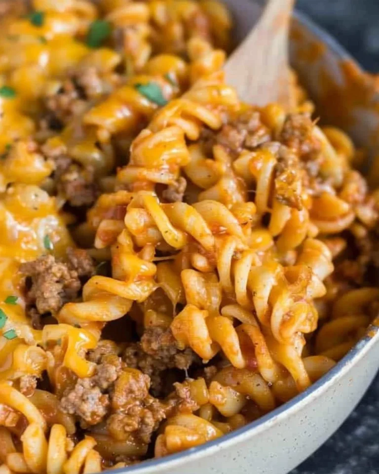Cheesy taco pasta served in a bowl with toppings