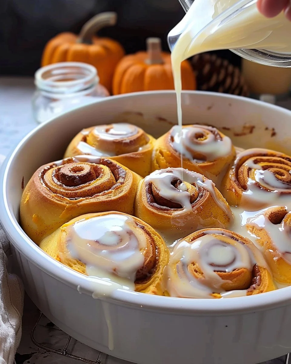 Delicious homemade pumpkin cinnamon rolls with icing on top.